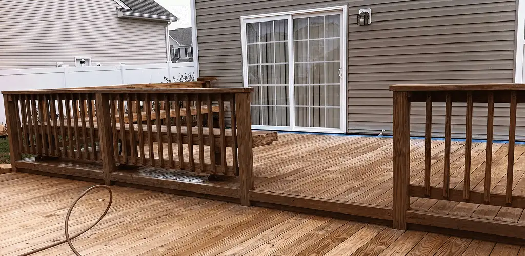 Deck sealing service protecting a backyard wood deck and railings in Buffalo, NY