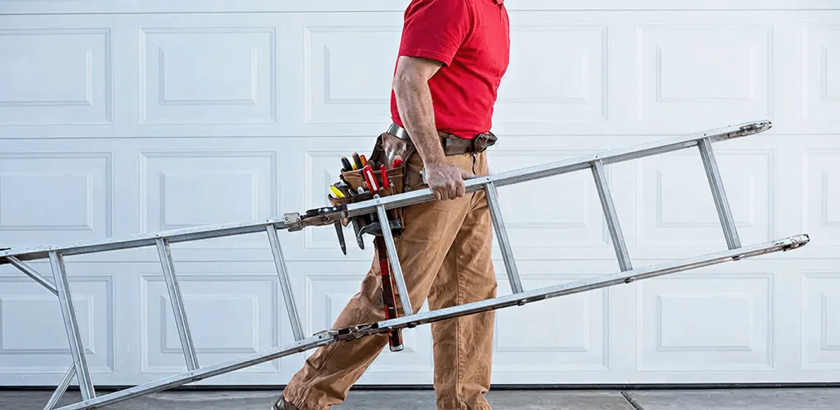 Garage door repair technician arriving with tools and ladder in Buffalo, NY