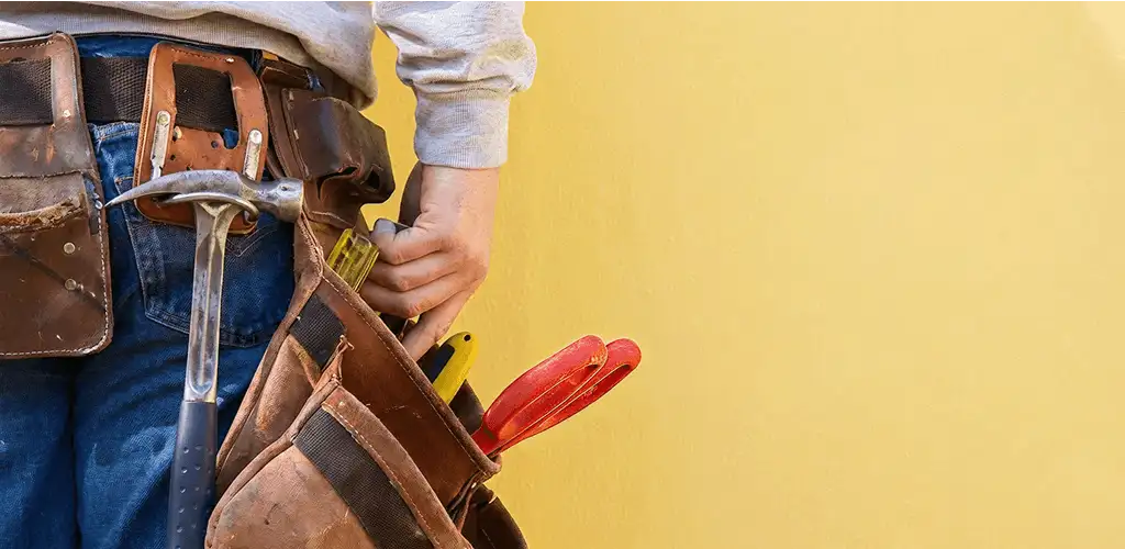 Handyman with tool belt ready for home repairs and maintenance in Buffalo, NY