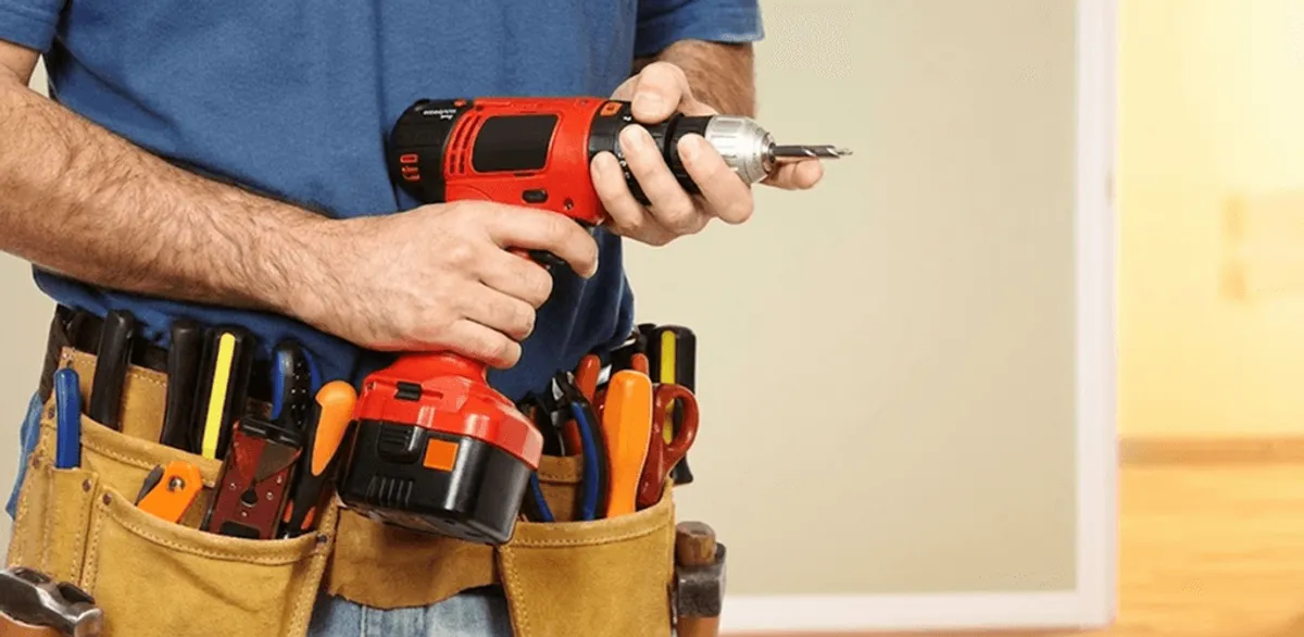 Handyman holding a power drill for home repairs and installations in Buffalo, NY
