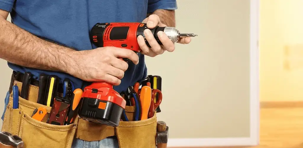 Handyman holding a power drill for home repairs and installations in Buffalo, NY