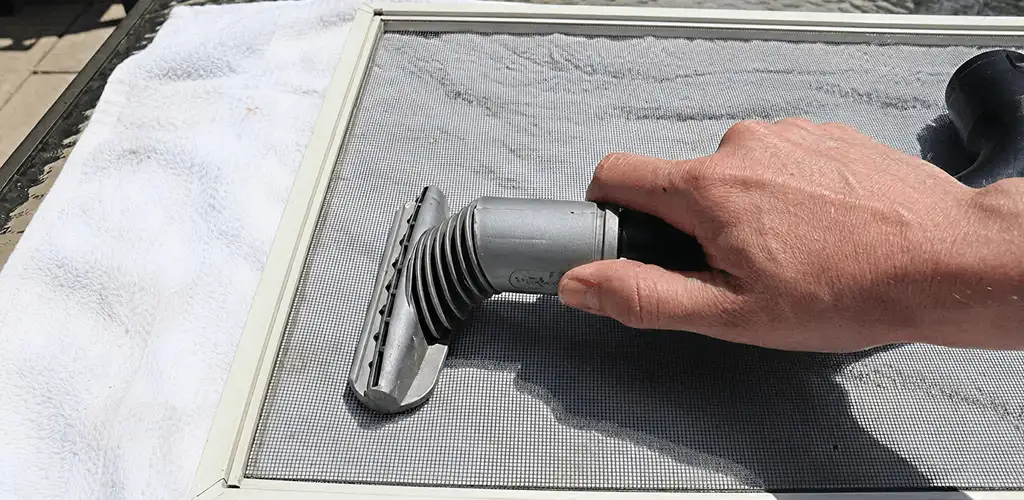 Window screen repair cleaning and fixing a damaged screen mesh in Buffalo, NY